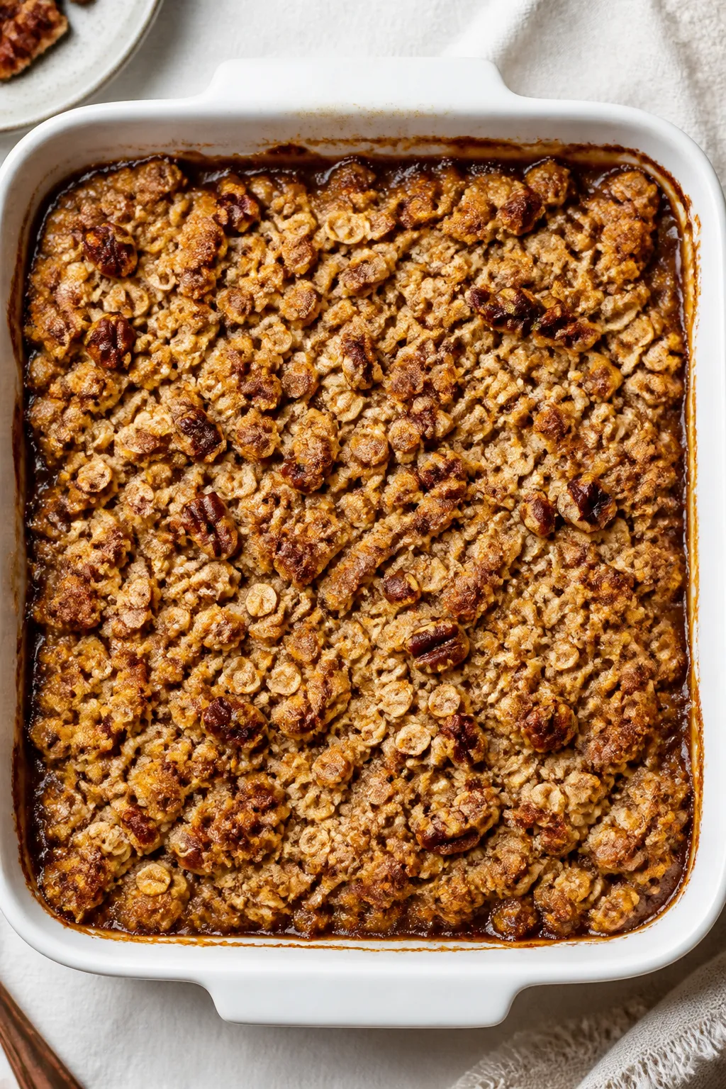 Overhead shot of a freshly baked Banana Crumble Bake just out of the oven in a 9-inch square ceramic